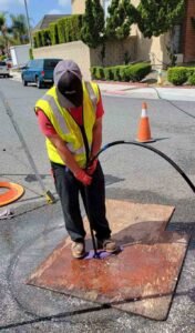 plumber clearing drains using hydro jetting