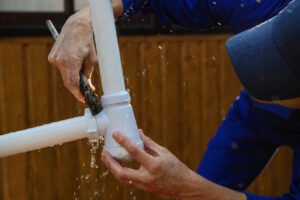 plumber fixing leaking pipe with a wrench Long Beach, CA